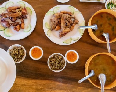 Selection of burmese dishes in rural Myanmar with skinny chicken and traditional soup