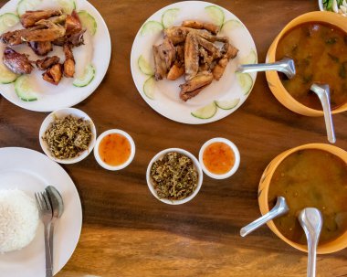 Selection of burmese dishes in rural Myanmar with skinny chicken and traditional soup