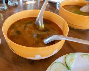 Selection of burmese dishes in rural Myanmar with skinny chicken and traditional soup