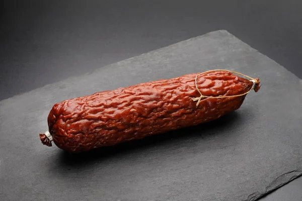 Traditional Krakowska dry smoked sausage on a dark background. — 스톡 사진