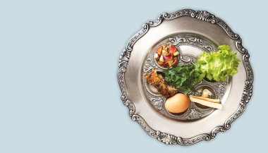Pesach plate, on a dove-grey background, banner with a copyspace. Traditional Jewish seder on the occasion of Passover festival. clipart