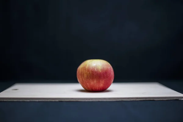 red apple on a black background