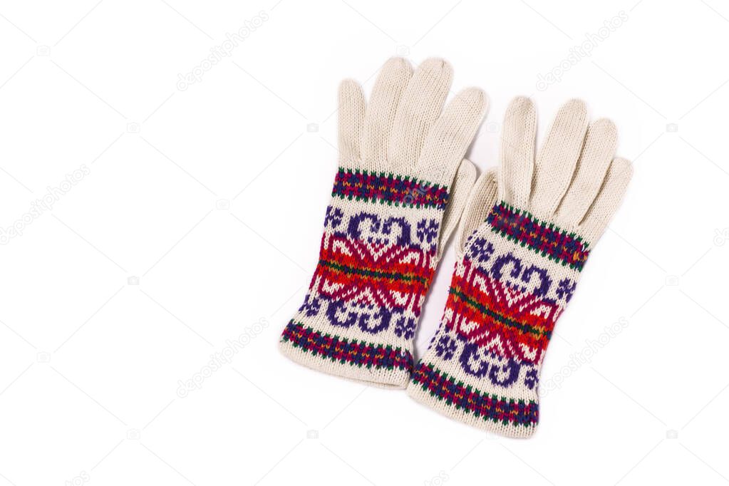 Warm colorful woolen knitted gloves isolated on a white background. Winter flatlay, top view, mockup.