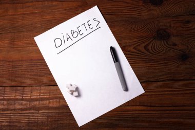 Şeker Hastalığını Durdur, beyaz kağıt üzerinde şeker küpleri ile birlikte...