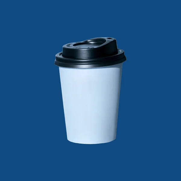 Café para ir sobre un fondo azul aislado. Copa de papel kraft en blanco con tapa negra, bebidas calientes para llevar, tienda, menú de café . — Foto de Stock