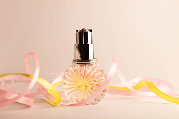 Perfume bottle on light background. Blank perfumery mockup, spa branding concept. Glamour fragrance, eau de parfum