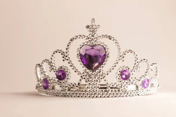 Silver crown with violet heart diamonds isolated on light background. Purple crystal headband. Female Little miss tiara. — Stock Photo, Image