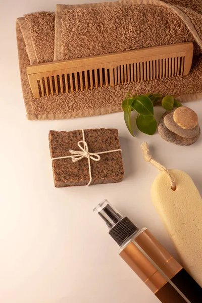 Spa and wellness concept, natural coffee scrub soap, oil cosmetics spray, peeling sand stone,towel,natural wood haircomb — 스톡 사진