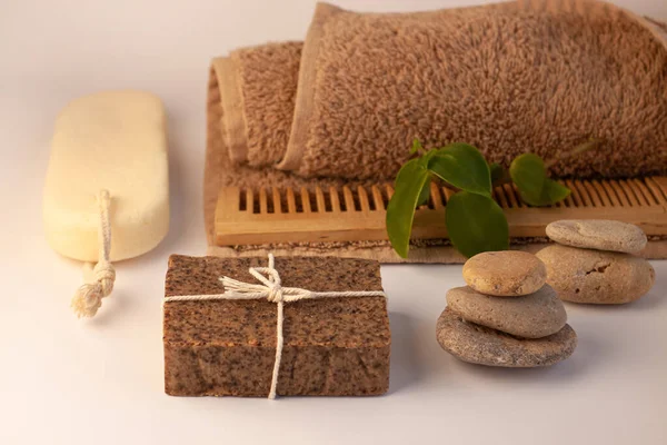 Spa i wellness koncepcja, naturalne mydło do szorowania kawy, spray kosmetyki olejowe, peeling piaskowca, ręcznik, naturalny grzebień do włosów drewna — Zdjęcie stockowe