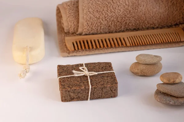 Spa and wellness concept, natural coffee scrub soap, oil cosmetics spray, peeling sand stone,towel,natural wood haircomb — 스톡 사진