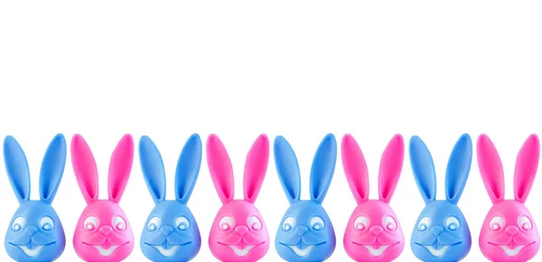 Funny colorful bunnies on white background. Easter banner,web site header. Pink and blue rabbits creative minimal style.