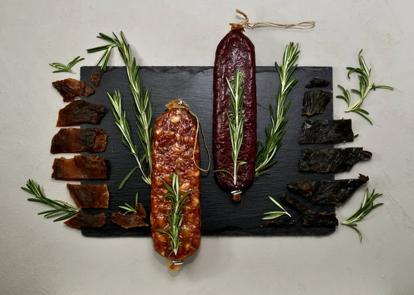 Raw Smoked Beaver Roe Deer Sausages Jerky Wild Sprigs Rosemary — Stock Photo, Image