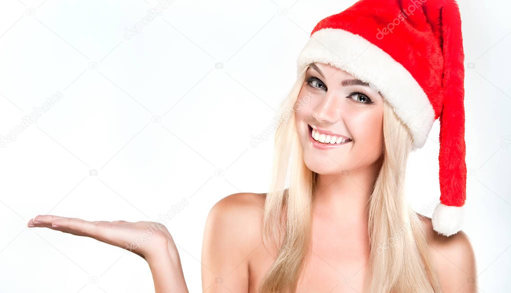  girl in  Santa hat shows  product