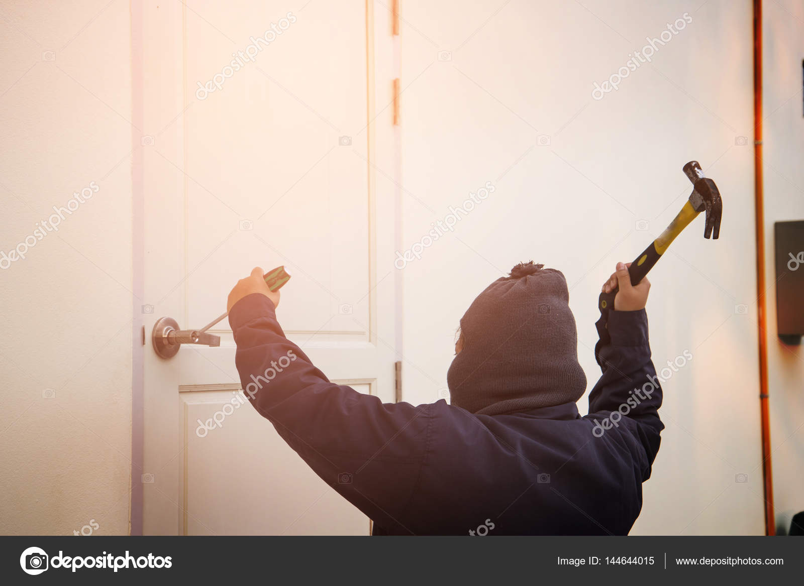 Burglar Trying To Break Into A House With A Hammer And