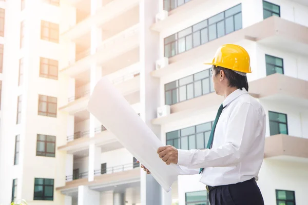 Weergave van een ingenieur en de werknemer controle-plan inzake de bouw sit — Stockfoto