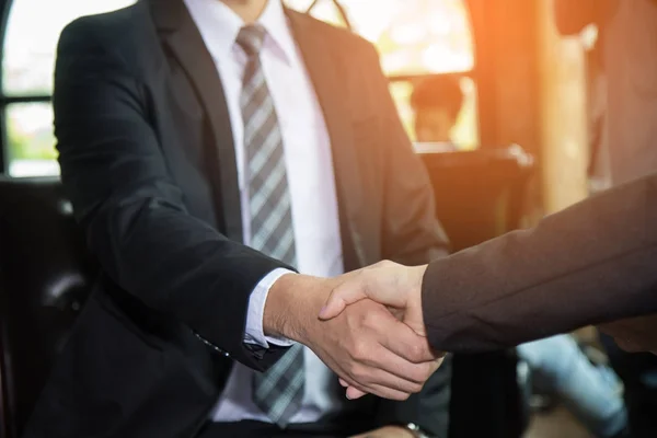 Good deal. Close-up of two business people shaking hands while s