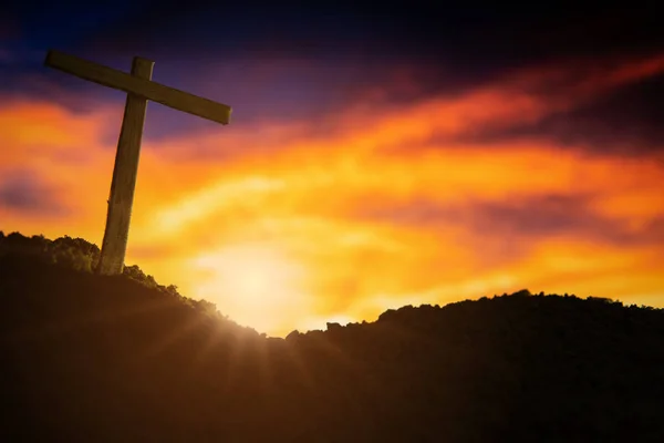 Cruz de madeira conceitual ou forma de símbolo de religião sobre um céu de pôr do sol — Fotografia de Stock