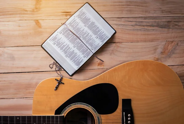 Christian man Bible study. Bible, books and guitar worship God.