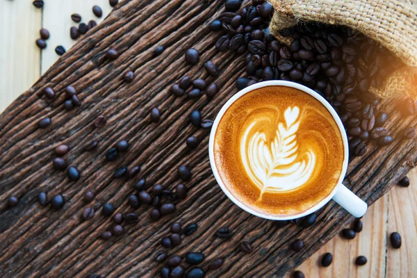 Cappuccino koffie en koffieboon op hout textuur achtergrond. br — Stockfoto