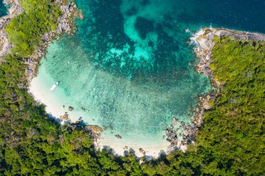 Aerial view drone shot ocean waves, Beautiful tropical beach and rocky coastline and beautiful forest. Nga Khin Nyo Gyee Island Myanmar. Tropical seas and islands in southern Myanmar clipart