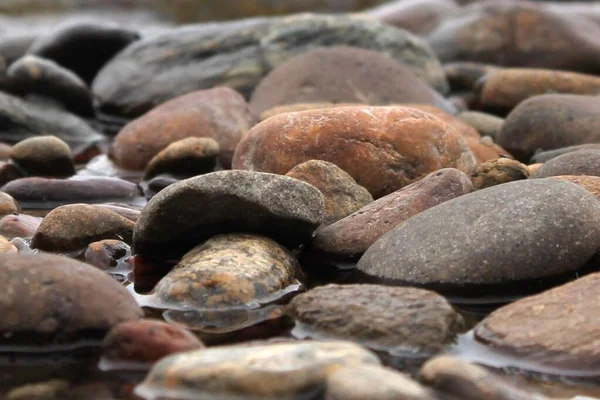 large river stones in water close-up. Beautiful closeup for decoration design. Landscape background. Zen stones balance. Travel wild nature. Beautiful scenic view. Background, texture.