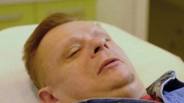 a man lies and prepares for a medical procedure