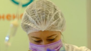 nurse prepares system for intravenous infusion