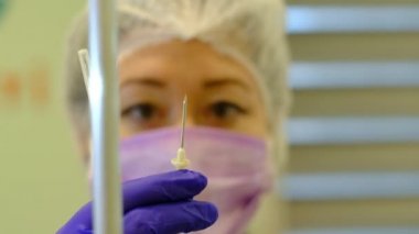 nurse prepares system for infusion therapy