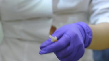 nurse attaches a butterfly catheter