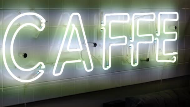 Neon luminous inscription caffe filmed on video with hand — Stock Video