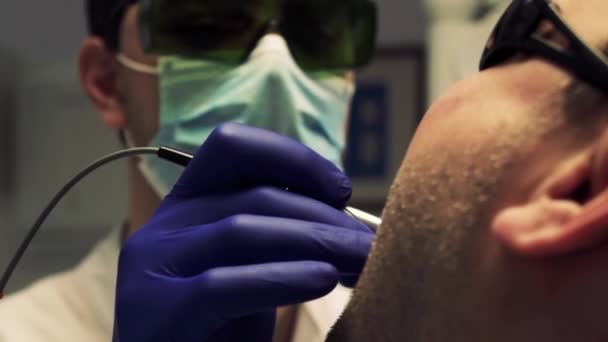 Стоматолог лечит зубы у пациента — стоковое видео