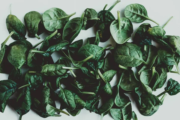 Spinach leaves in the form of an abstract pattern. Trendy ugly food, concept of zero waste life.