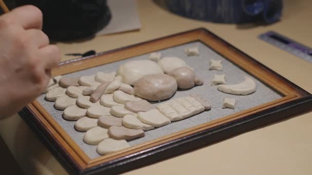 Female artist is cleaning the handmade painting before varnish process — Stock Video