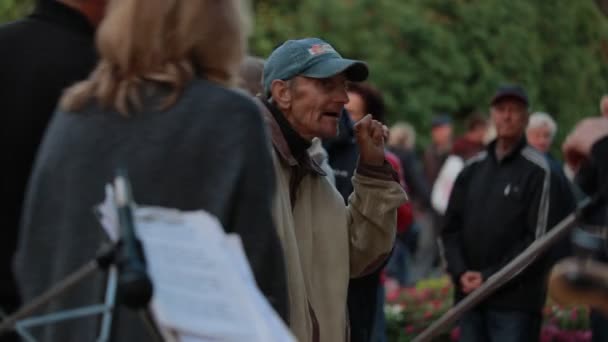 Chernihiv, ukraine 22 spt 2019. alter mann imitiert gesang in imaginärem mikrofon bei der rentnertanzparty im park — Stockvideo