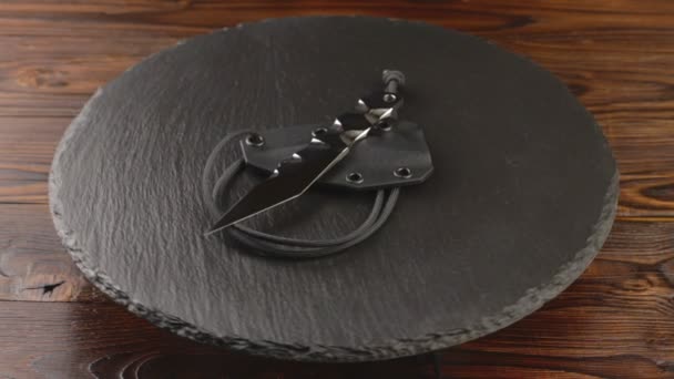 Custom hand crafted japanese kiridashi knife on the turning slate board table — Stock Video