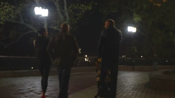 Chernihiv, Ukraine. 13 oct 2019. Couples are having an evening walk along the autumn park at night or late evening — Stock video