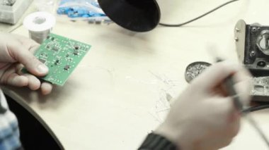 Bir işçi bir elektronik pano oluşturmaya çalışıyor. Yakın plan..