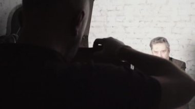 Bir fotoğrafçı, stüdyoda eski bir kamerayla fotoğraf çekiyor..