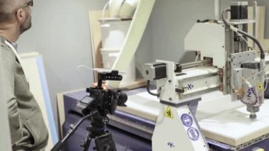Kameraman bir fotoğrafçının elinde video çekerken bir DSLR kamerasının yakın çekimi.