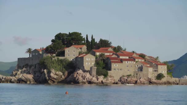 Houses with red tiled roofs. Architecture of Sveti Stefan. Montenegro. — Stock Video