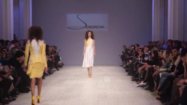 Moda gösterisinde podyumda manken kız.