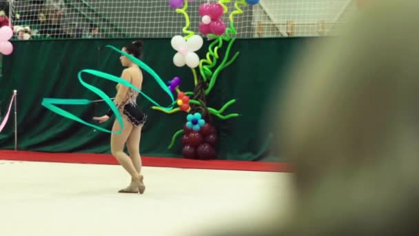 Girl gymnast with ribbon during the competition. Slow motion. Kyiv. Ukraine. — Stock Video