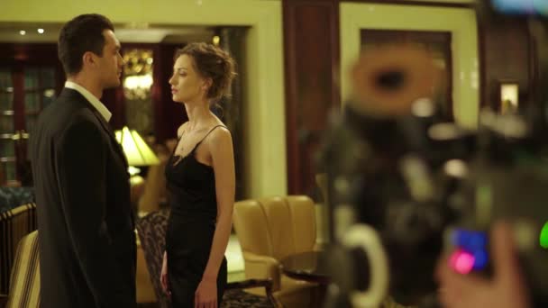 A male actor and female actress plays a role during filming. — Stock Video