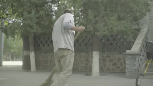 Male janitor with broom. Beijing. China. Asia — Stock Video