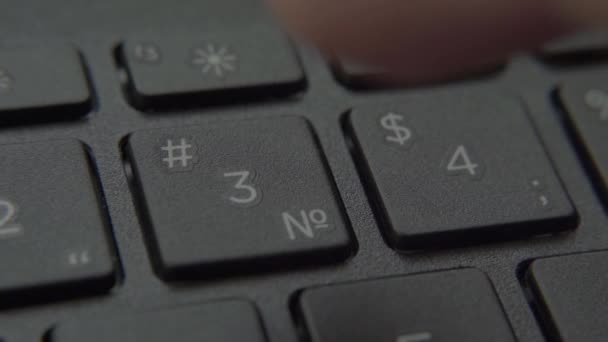 The finger presses a button with a number on the keyboard — Stock Video