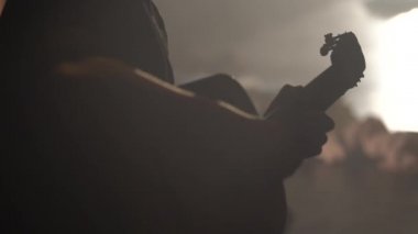 Male guitarist plays the guitar in the dark. Kyiv. Ukraine