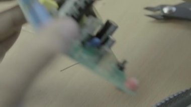 Bir işçi bir elektronik pano üretimi üzerinde çalışıyor. Yakın plan..