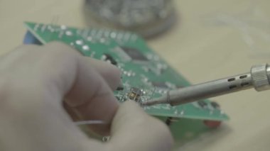 Bir işçi bir elektronik pano üretimi üzerinde çalışıyor. Yakın plan..