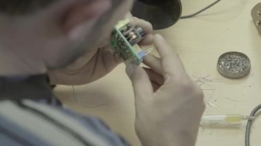 Bir işçi bir elektronik pano üretimi üzerinde çalışıyor. Yakın plan..