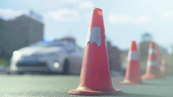 Police cone on the road. Place of accident. Transport. Road traffic. Sign. Kyiv. — ストック動画